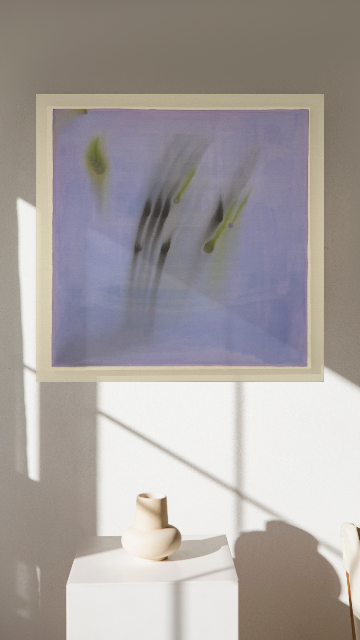 Abstract artwork on a wall with a vase below