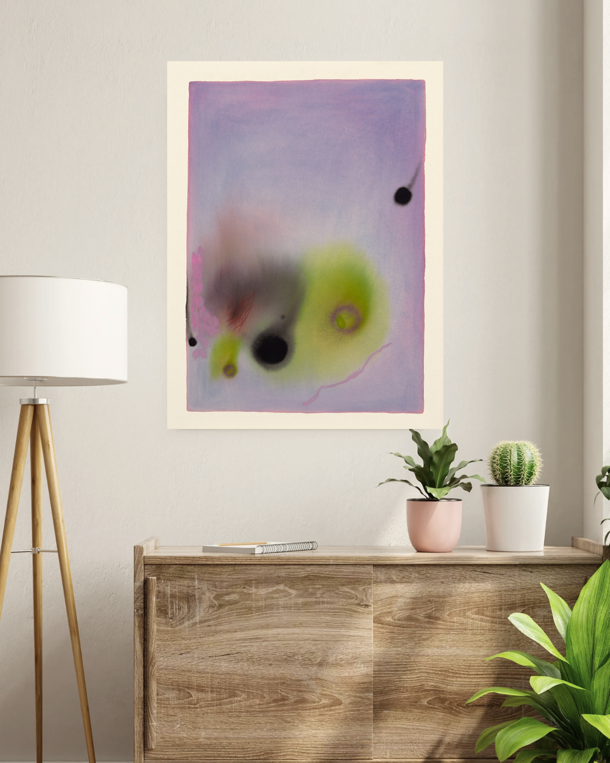 Abstract art piece on a wall above a wooden cabinet with plants.