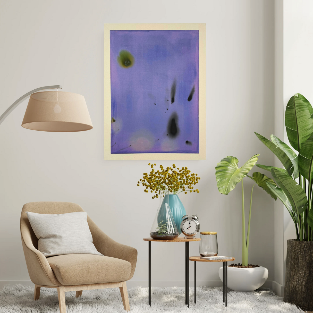 Modern living room with a beige armchair, abstract art, and decorative items.